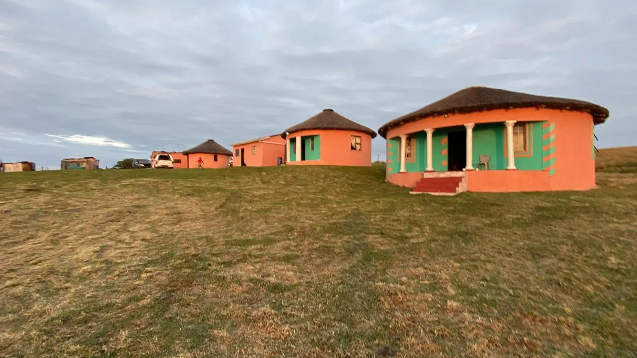 Traditional orange and green rondavels